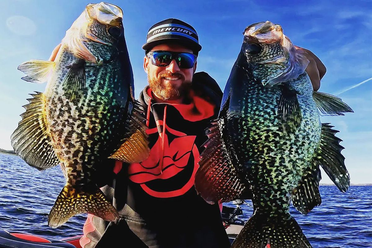 Captain Erik Tilson displaying two crappie from a guide trip