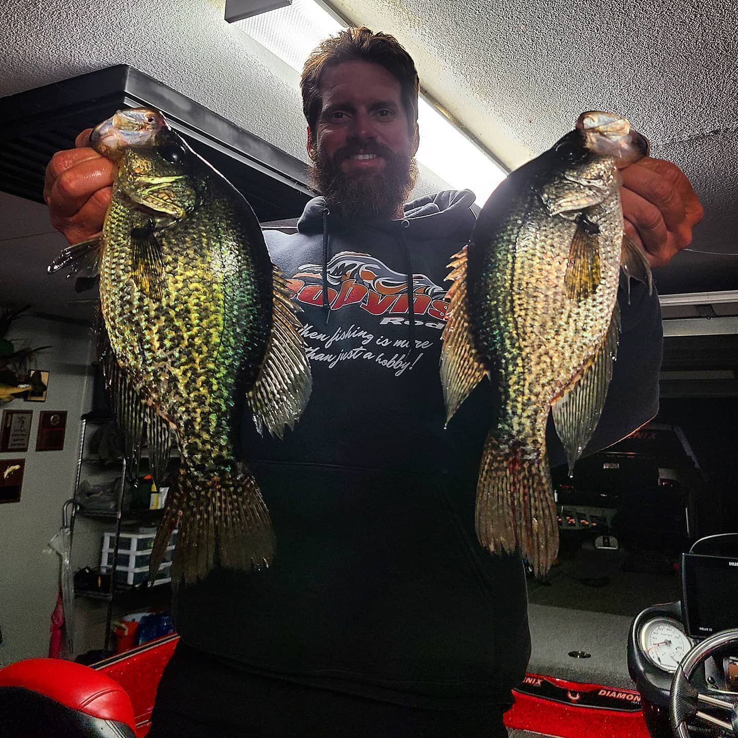 Captain Erik Tilson holding two crappie