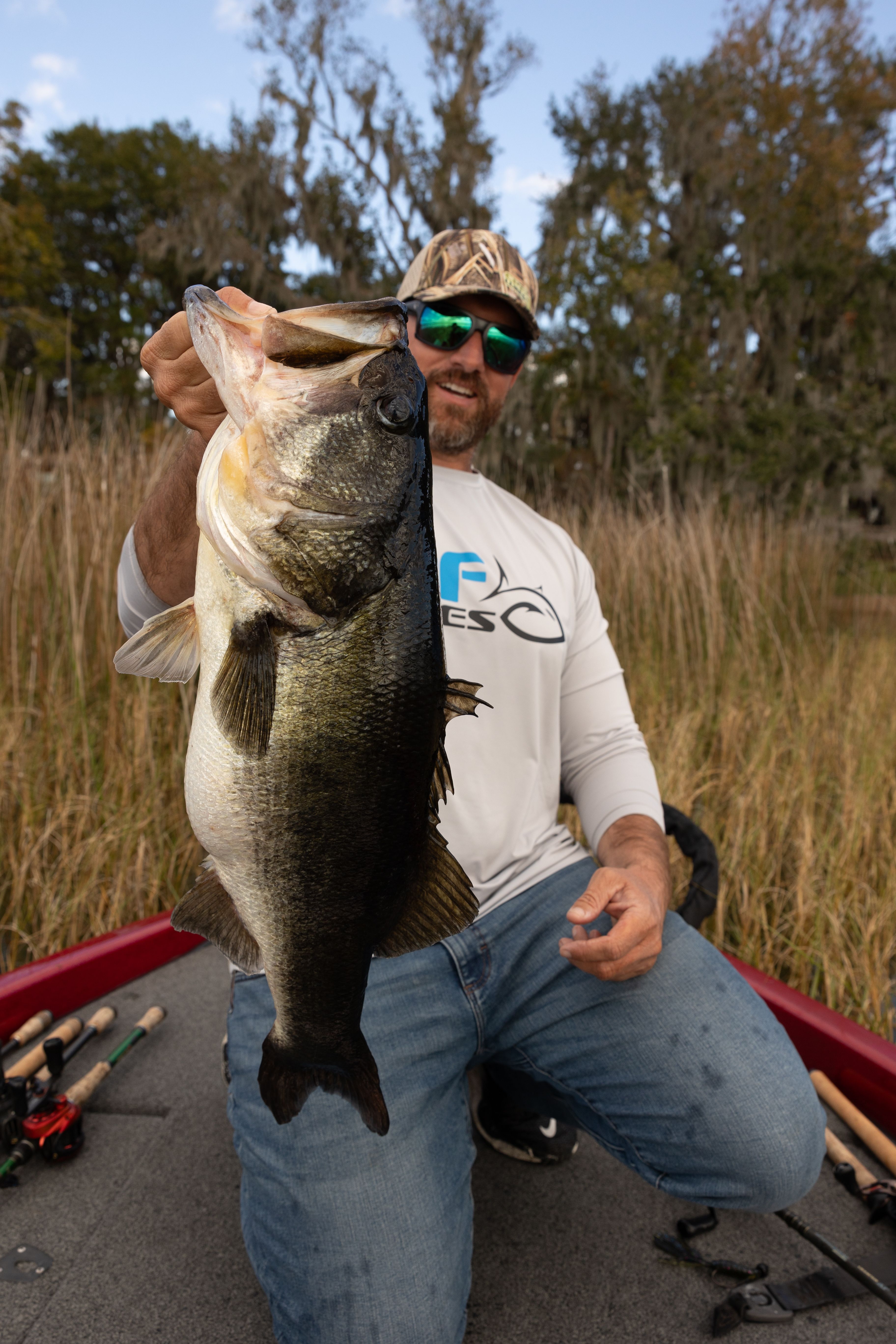 Captain Erik Tilson holding a largemouth bass