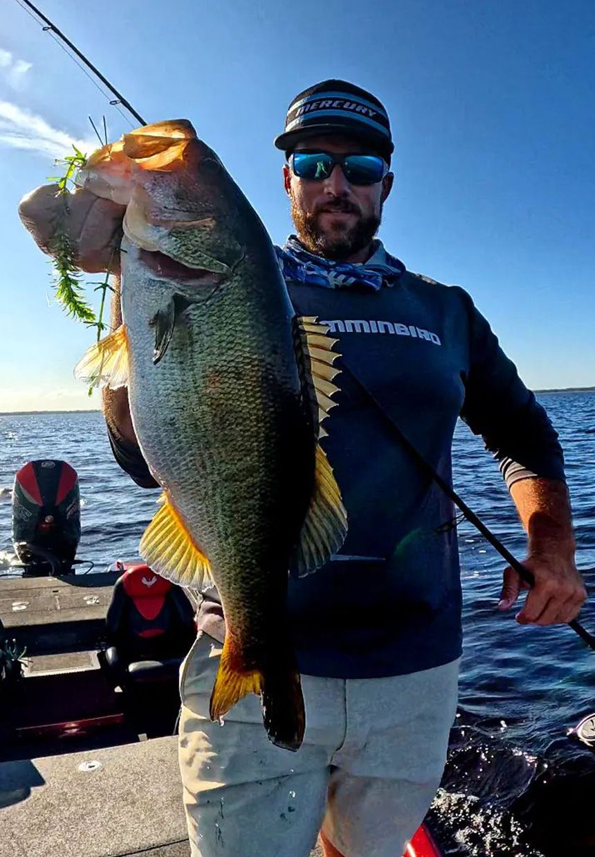 Captain Erik Tilson holding a largemouth bass